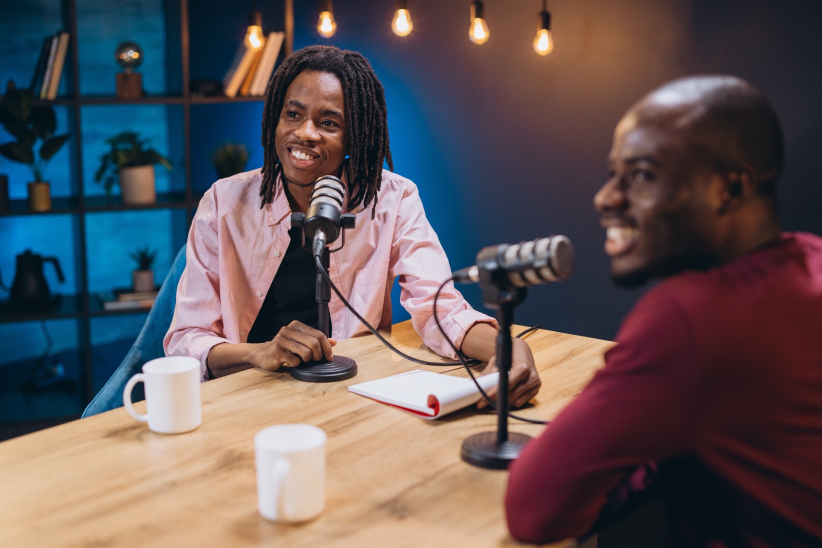 Two hosts recording an episode