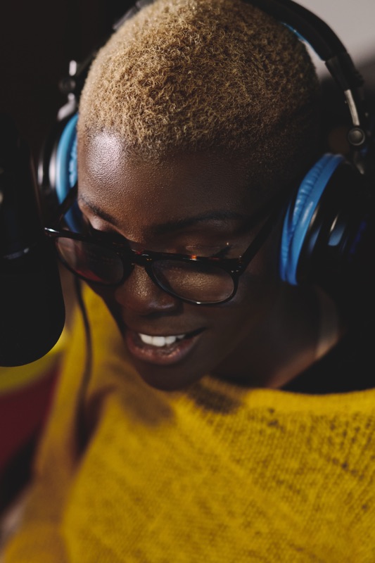 Woman podcasting at a microphone